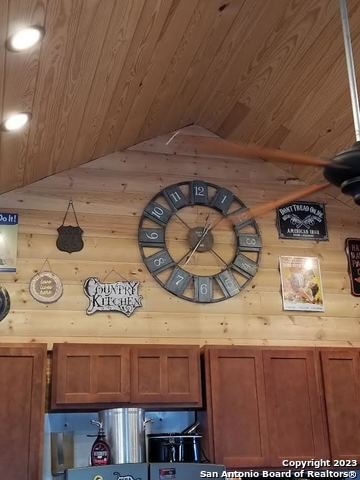 interior details featuring wooden ceiling and wood walls