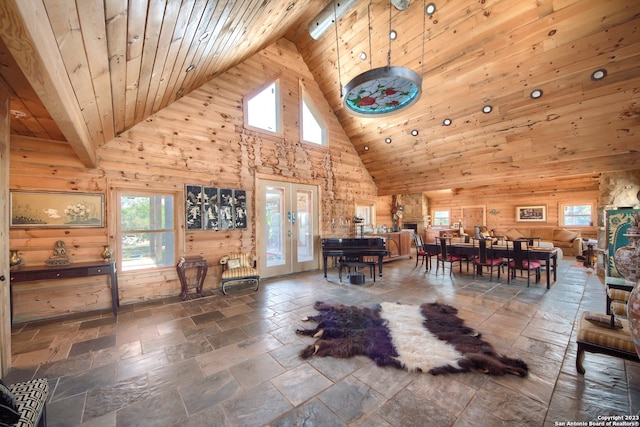 interior space featuring wood ceiling, dark tile floors, high vaulted ceiling, and french doors