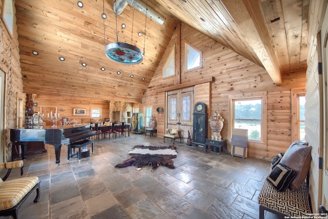 interior space featuring dark tile flooring, wood ceiling, high vaulted ceiling, and beamed ceiling