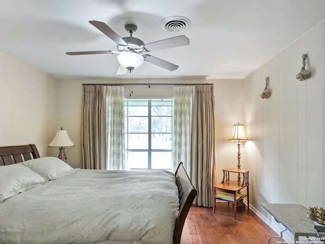 bedroom featuring ceiling fan, dark wood-type flooring, and ornamental molding