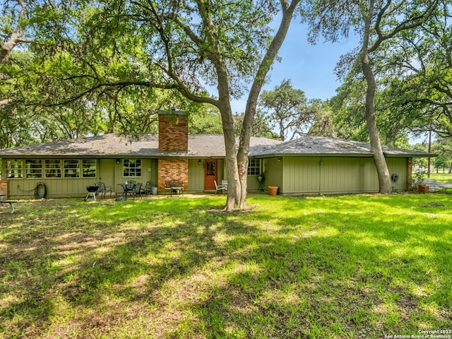 back of house with a yard