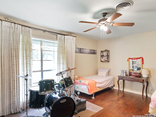 bedroom with ceiling fan and dark wood-type flooring