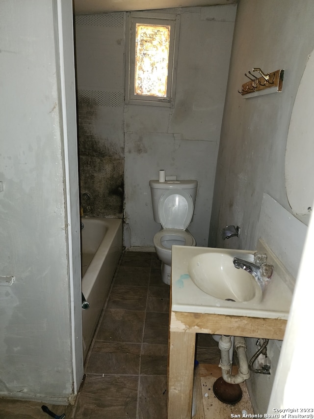 bathroom with tile floors, toilet, and vanity