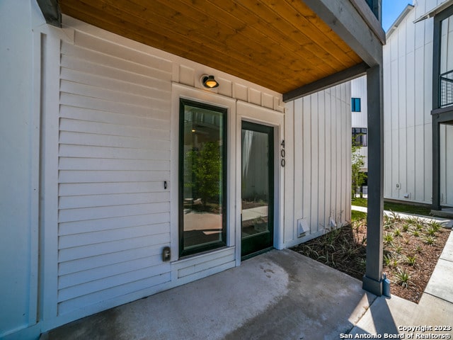 view of exterior entry featuring a patio area