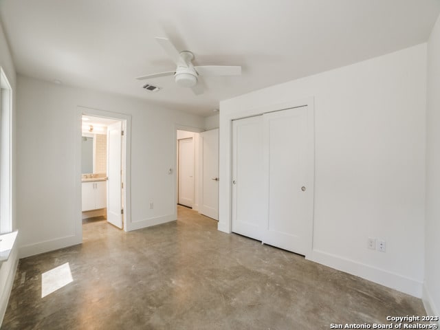 unfurnished bedroom with a closet, ceiling fan, and ensuite bathroom