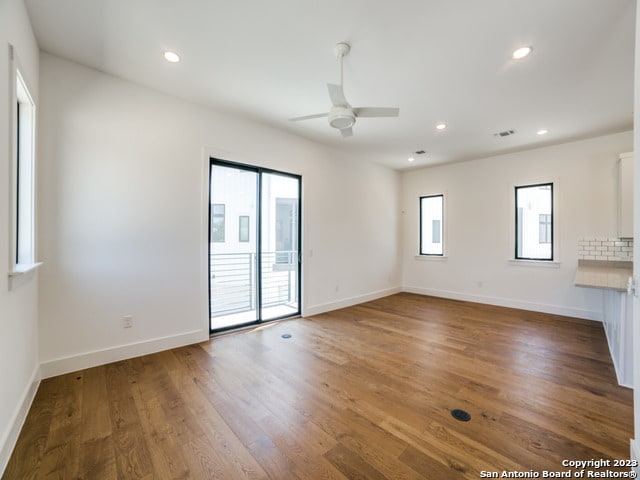 unfurnished room with dark hardwood / wood-style floors and ceiling fan