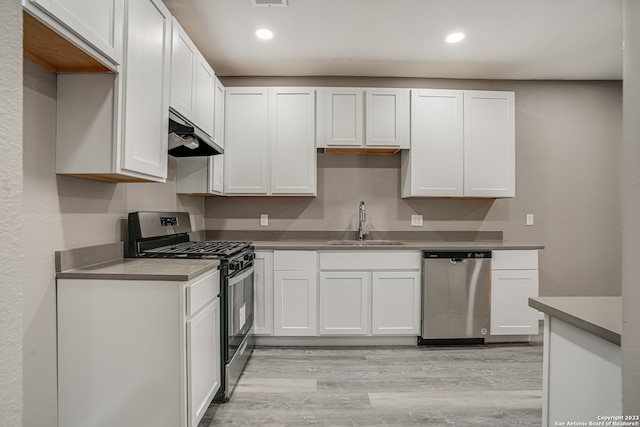 kitchen featuring sink, stainless steel appliances, light wood-type flooring, and white cabinets