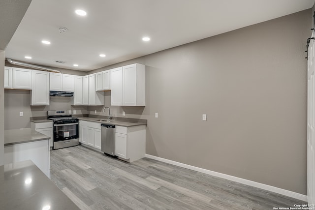 kitchen with white cabinets, light hardwood / wood-style flooring, sink, and stainless steel appliances