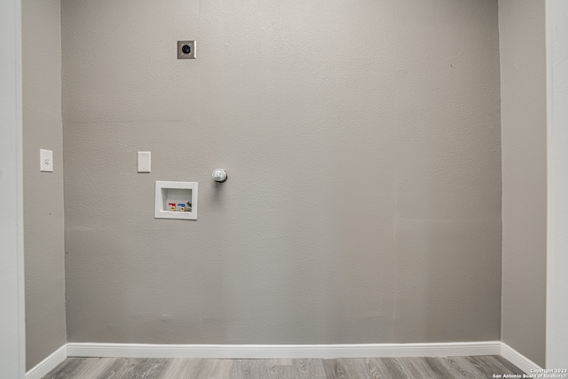 washroom with washer hookup, electric dryer hookup, and dark wood-type flooring