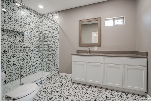 bathroom featuring tile floors, toilet, and vanity with extensive cabinet space