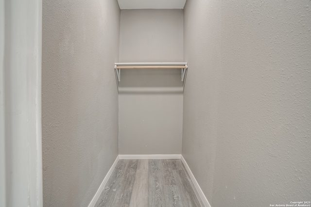 spacious closet featuring hardwood / wood-style floors