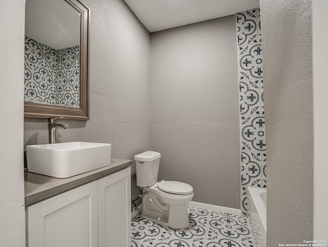 bathroom with vanity, tile floors, and toilet