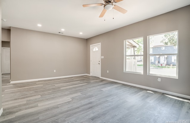 spare room featuring light hardwood / wood-style floors and ceiling fan