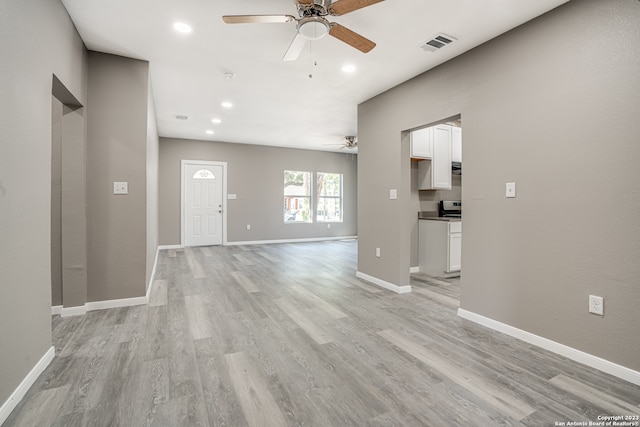 spare room with light hardwood / wood-style floors and ceiling fan