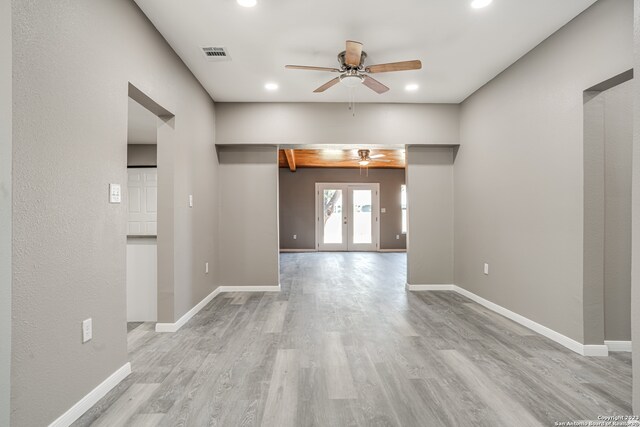 empty room with french doors, light hardwood / wood-style floors, and ceiling fan