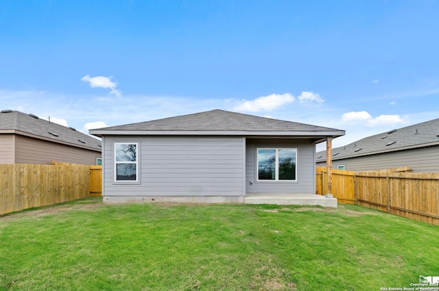 rear view of property with a yard