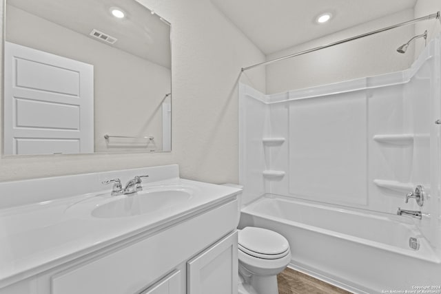 full bathroom featuring hardwood / wood-style flooring, vanity, toilet, and shower / tub combination