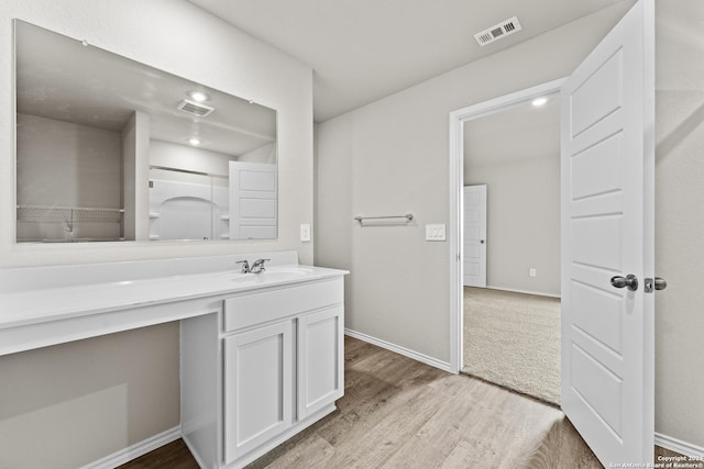 bathroom with hardwood / wood-style flooring and vanity