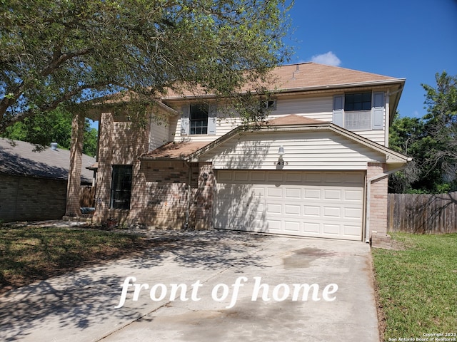 view of front property with a front lawn and a garage