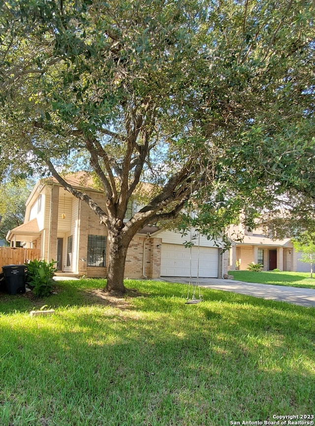 view of front of property with a front lawn and a garage