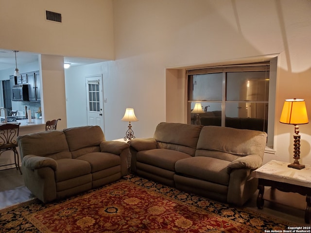 living room featuring a towering ceiling