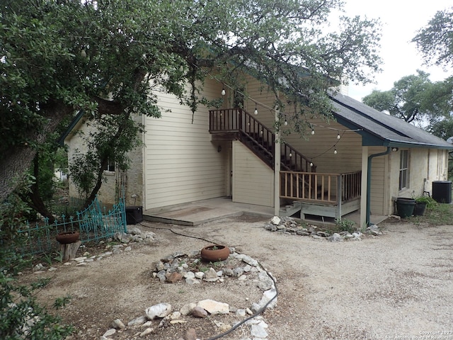 back of property featuring central air condition unit and a wooden deck