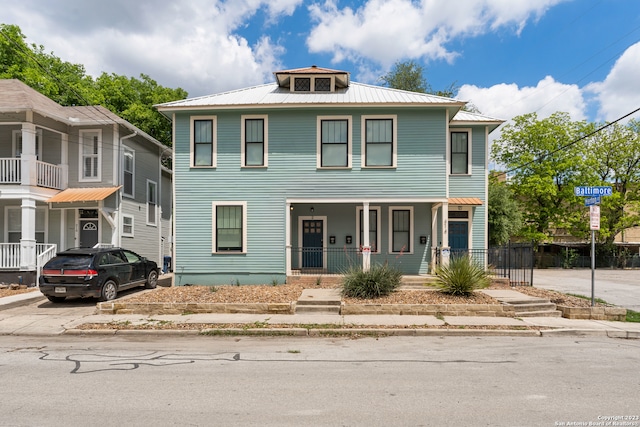 view of front of home featuring a balcony and a porch