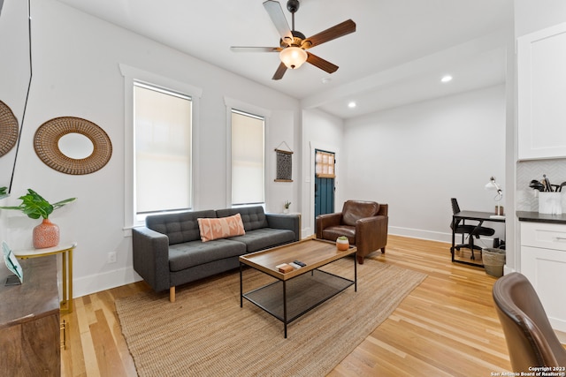 living room with light hardwood / wood-style floors and ceiling fan