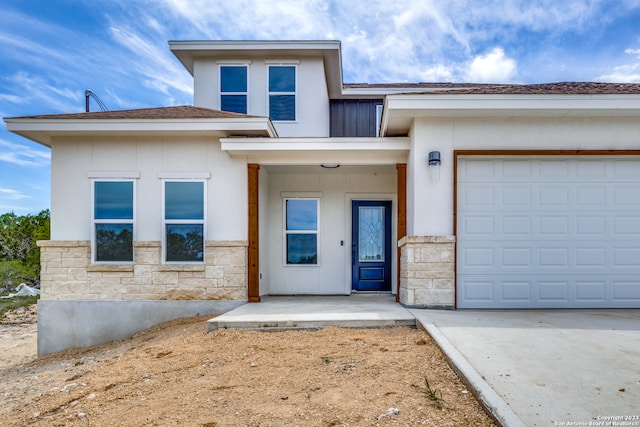 view of front of home featuring a porch and a garage