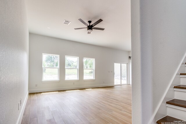 empty room featuring ceiling fan and light hardwood / wood-style flooring