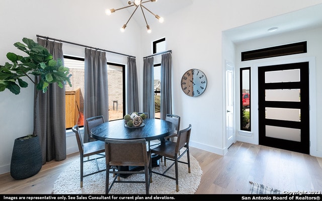 dining space featuring plenty of natural light, light hardwood / wood-style floors, and a chandelier