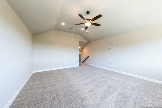 carpeted empty room with lofted ceiling and ceiling fan