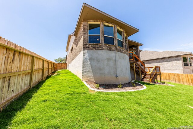 rear view of house with a yard