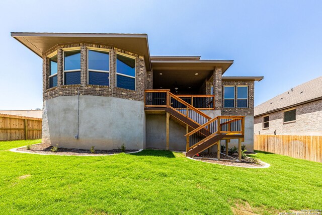 rear view of house with a yard