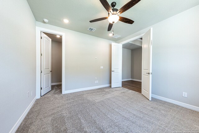 unfurnished bedroom featuring light colored carpet and ceiling fan