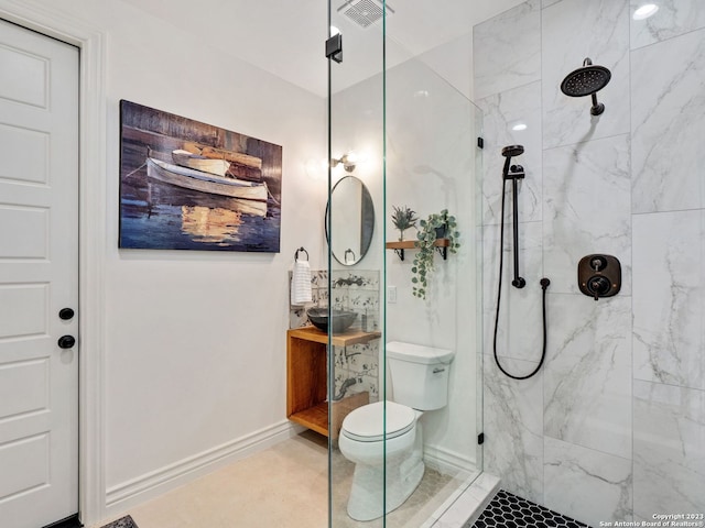 bathroom with toilet, a tile shower, and tile floors