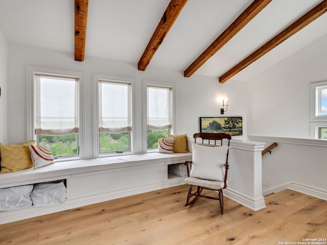 sitting room with vaulted ceiling with beams and light wood-type flooring