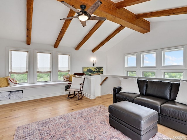 living room featuring vaulted ceiling with beams, ceiling fan, and light hardwood / wood-style flooring