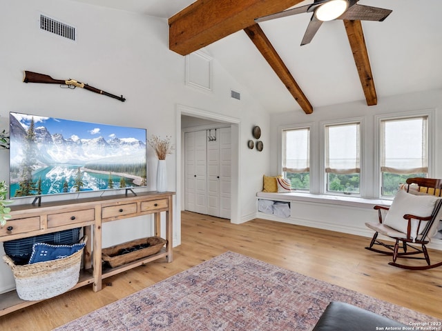 living room with beamed ceiling, high vaulted ceiling, ceiling fan, and light wood-type flooring