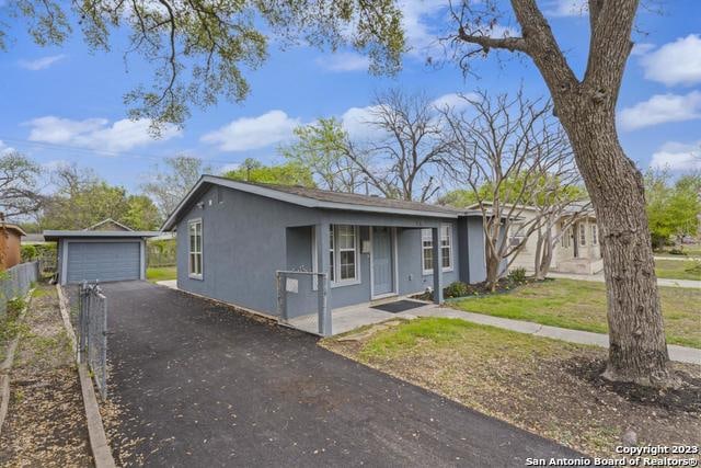 single story home with a front yard and a garage