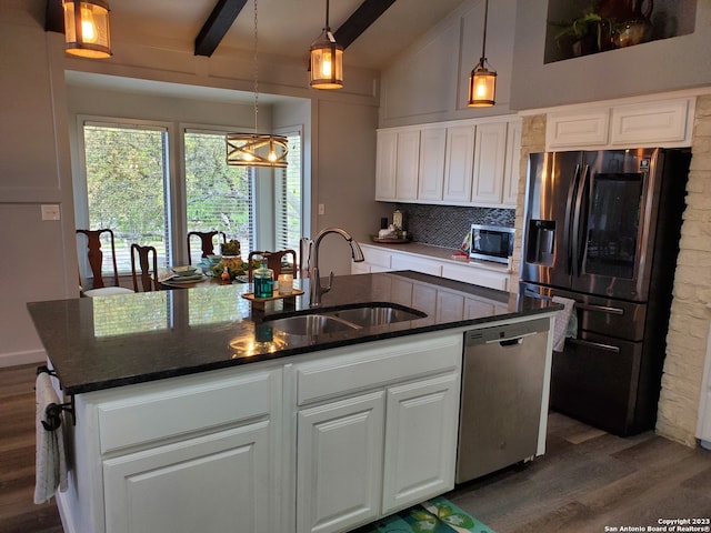 kitchen with dark hardwood / wood-style floors, an island with sink, stainless steel appliances, and white cabinetry