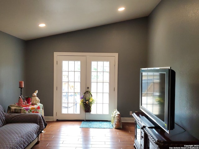 entryway featuring vaulted ceiling, wood-type flooring, and french doors