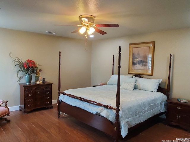 bedroom with dark hardwood / wood-style floors and ceiling fan