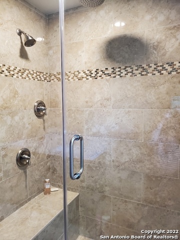 bathroom with a shower with shower door