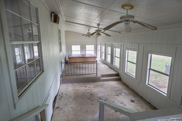 unfurnished sunroom with ceiling fan and plenty of natural light