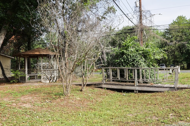 view of yard with a gazebo and a wooden deck