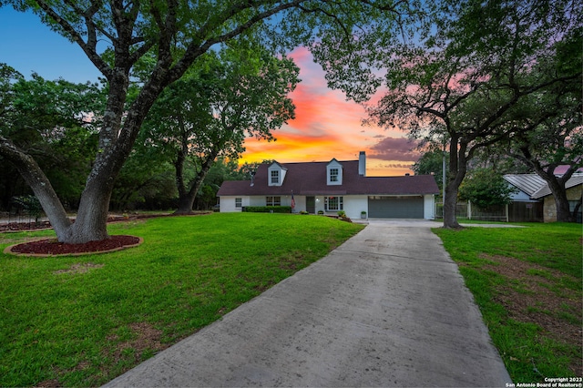 cape cod house with a lawn