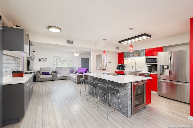 kitchen with backsplash, wine cooler, stainless steel appliances, and ceiling fan