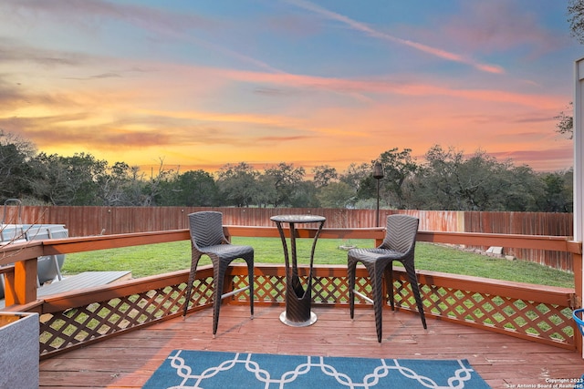 deck at dusk with a lawn