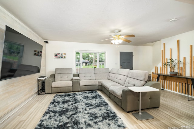 living room featuring ceiling fan and light wood-type flooring